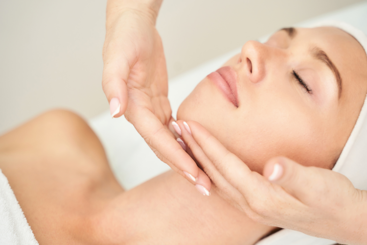 Close-up of a woman’s face receiving a rejuvenating facial massage with gentle techniques.